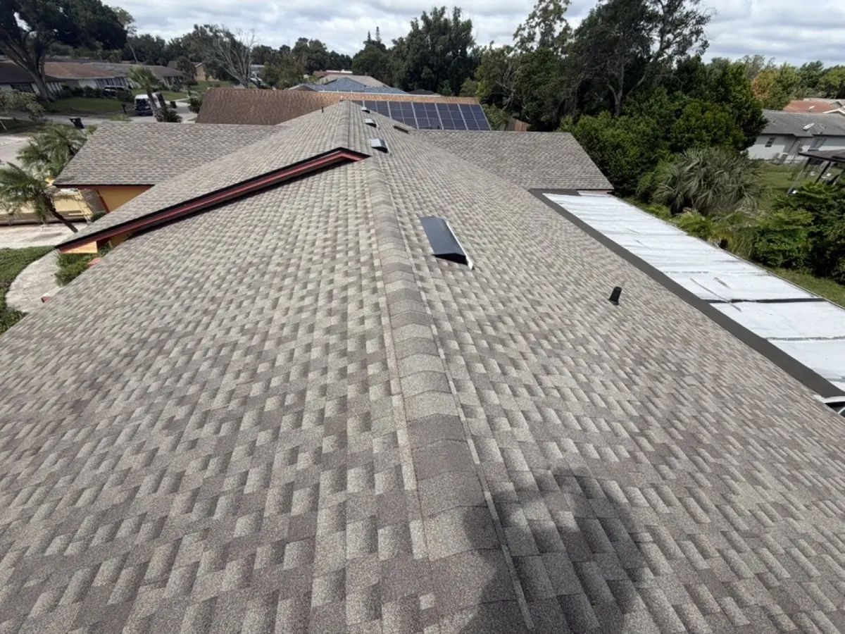 Finished architectural shingle roof with new ridge cap and off-ridge vents