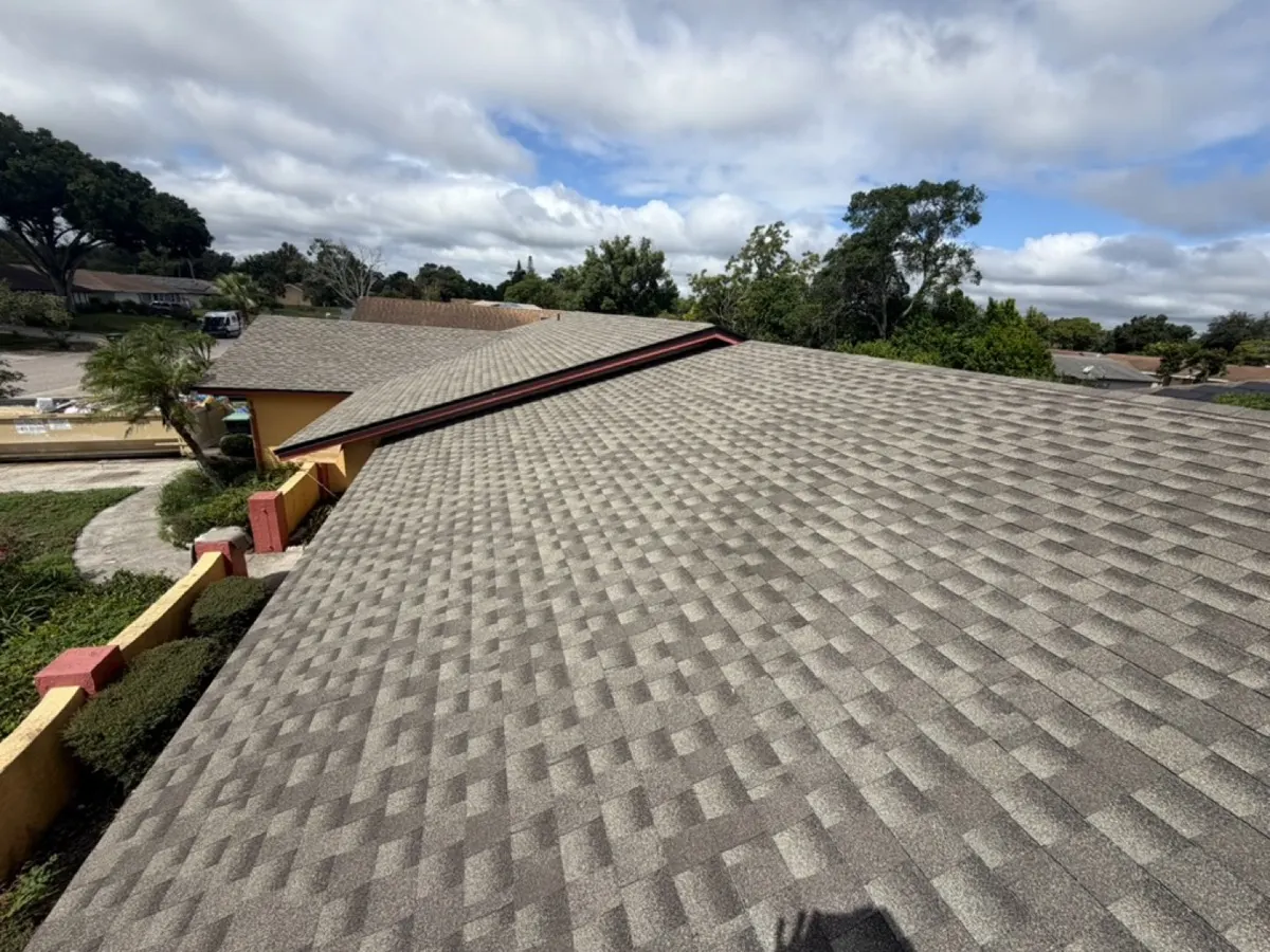 Finished front slope of a new architectural shingle roof with clean drip edge