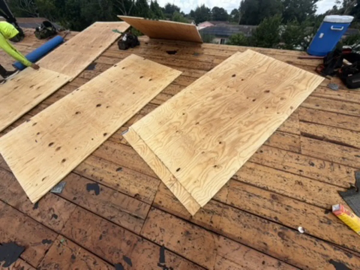 New plywood sheets cut in to replace rotten roof decking during a re-roof
